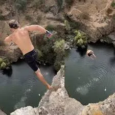 Moment man set world record in d£ath diving as he jumps off 144ft-high cliff (video)